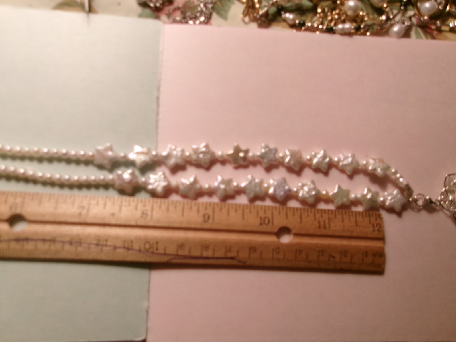 PEARL NECKLACE WITH STARS SLIPS OVER HEADSIZE 12 MM ON CENTER PEARL