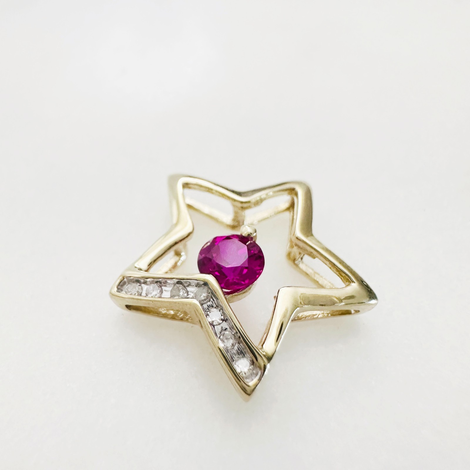 Solid 10K Yellow Gold .25ct Ruby & 7 Diamond Open Star Pendant 16mm, 1.2g