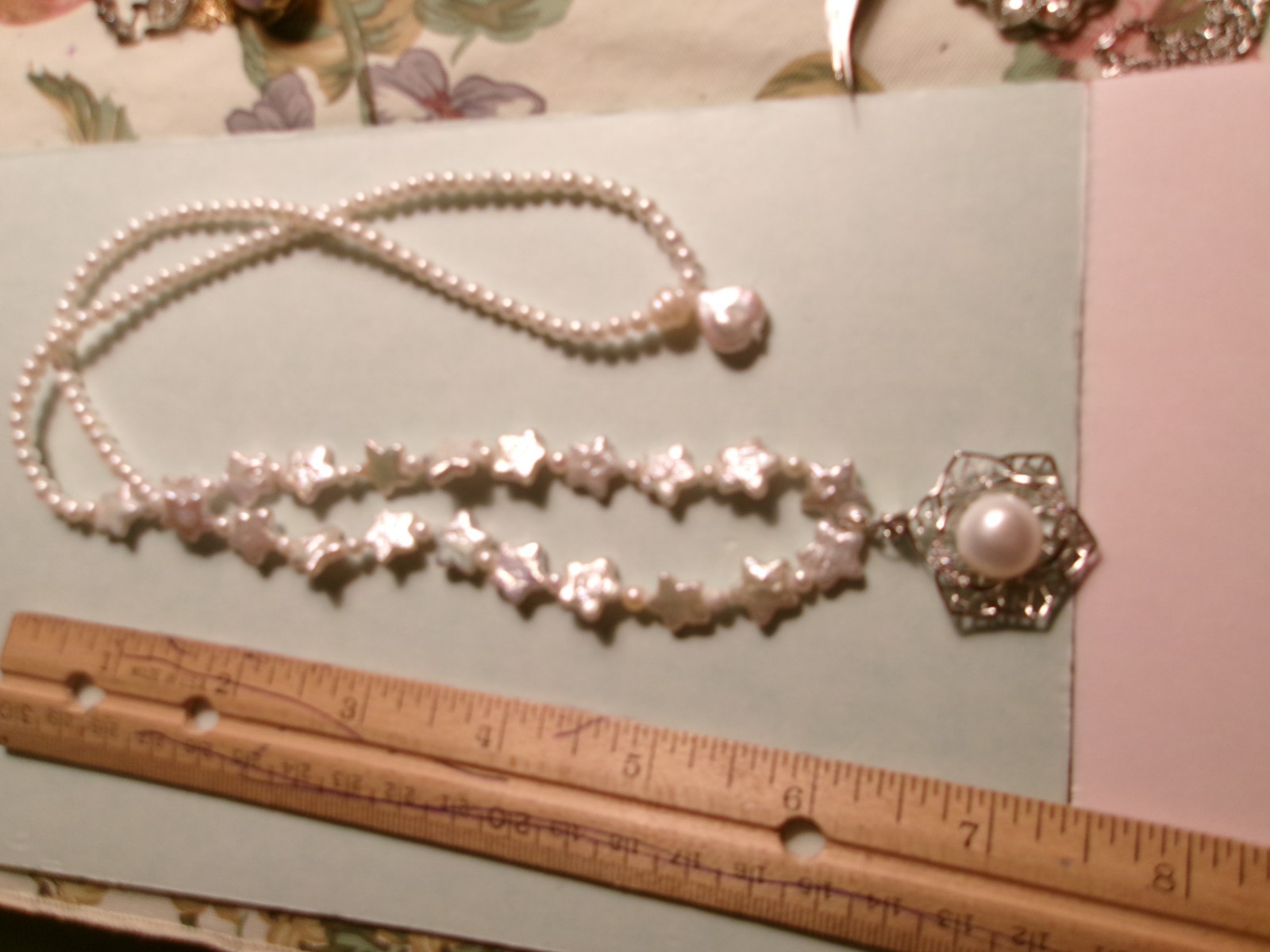 PEARL NECKLACE WITH STARS SLIPS OVER HEADSIZE 12 MM ON CENTER PEARL