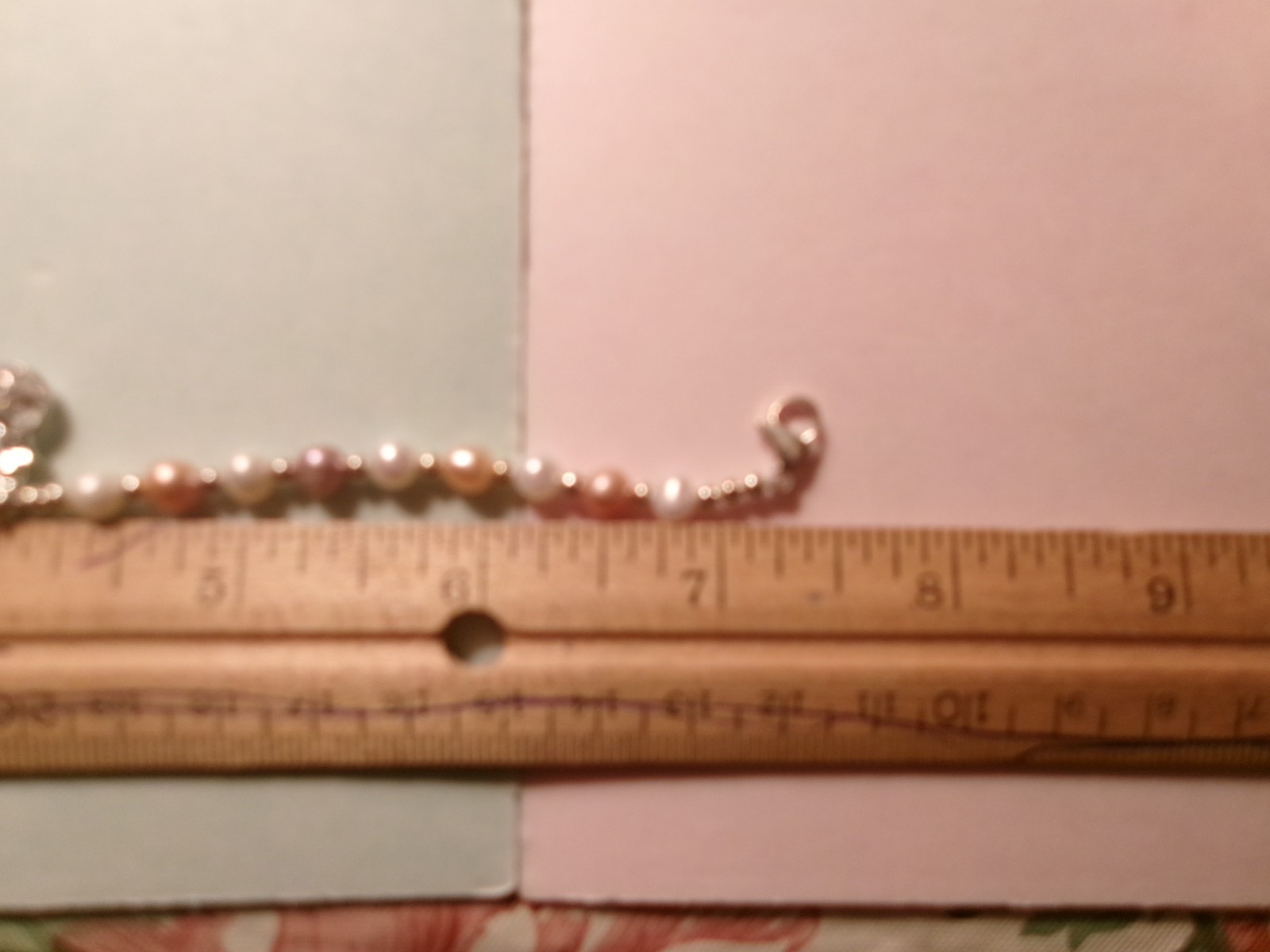 PEARL BRACELET HAS A GLASS DIAMOND IN A CAGE
