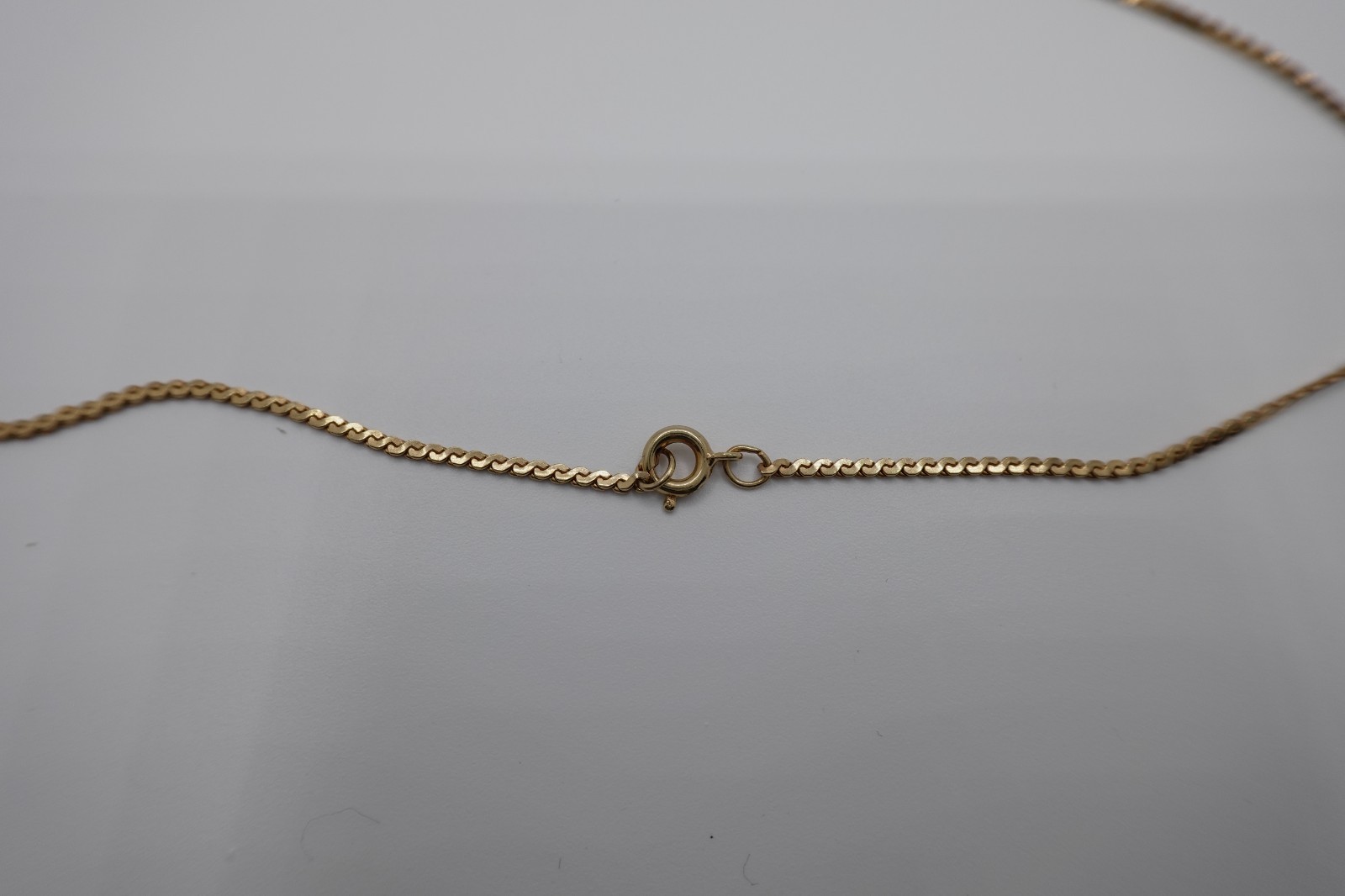 10k stamped gold pendant with unknown stones clasp on chain is stamped 1/2012
