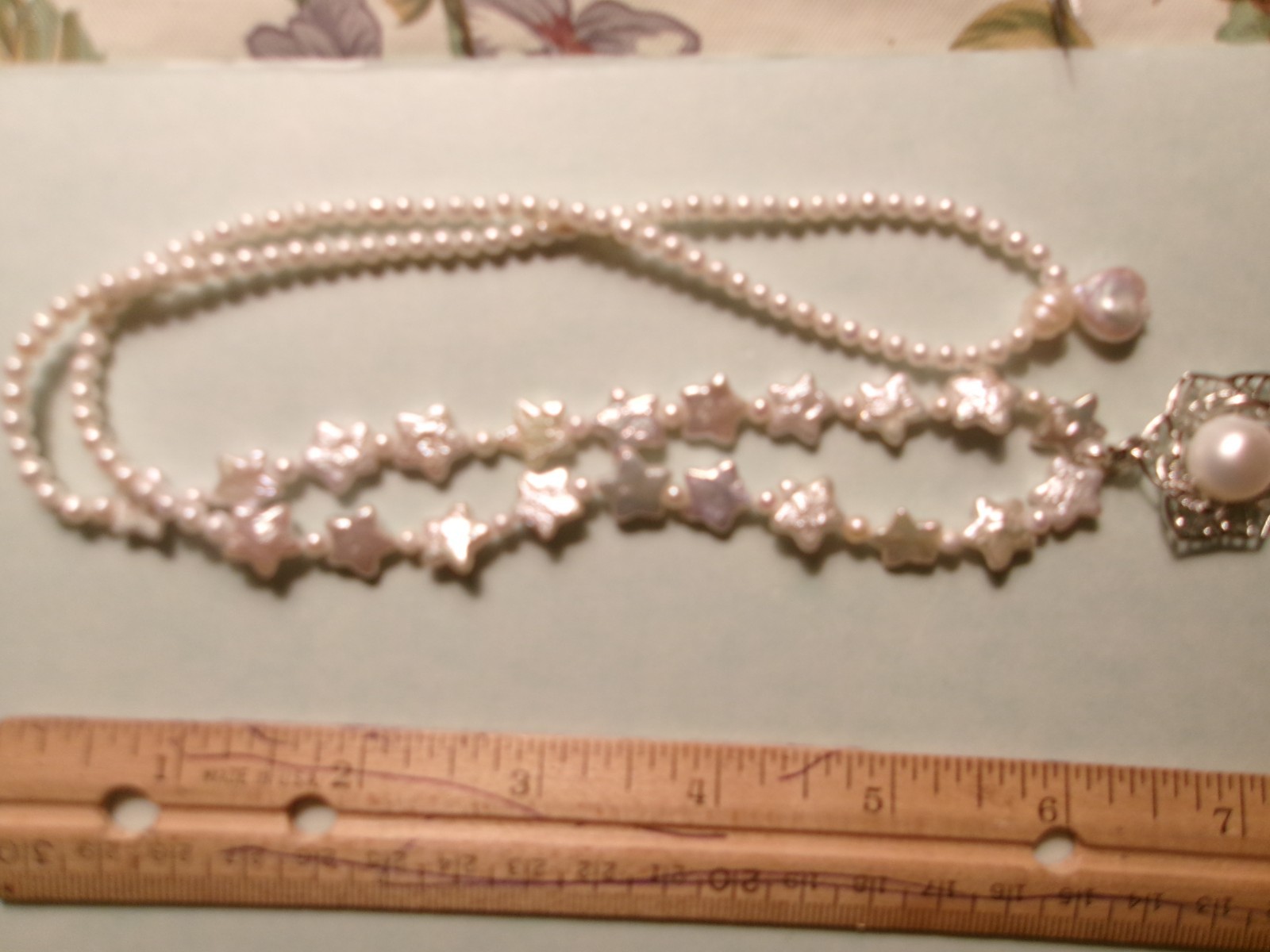 PEARL NECKLACE WITH STARS SLIPS OVER HEADSIZE 12 MM ON CENTER PEARL