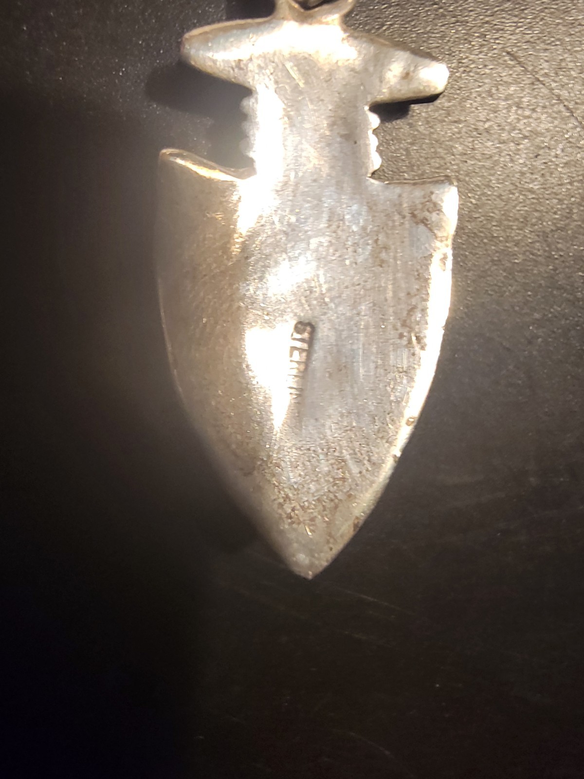 Sterling Silver arrowhead pendant features a detailed shield design