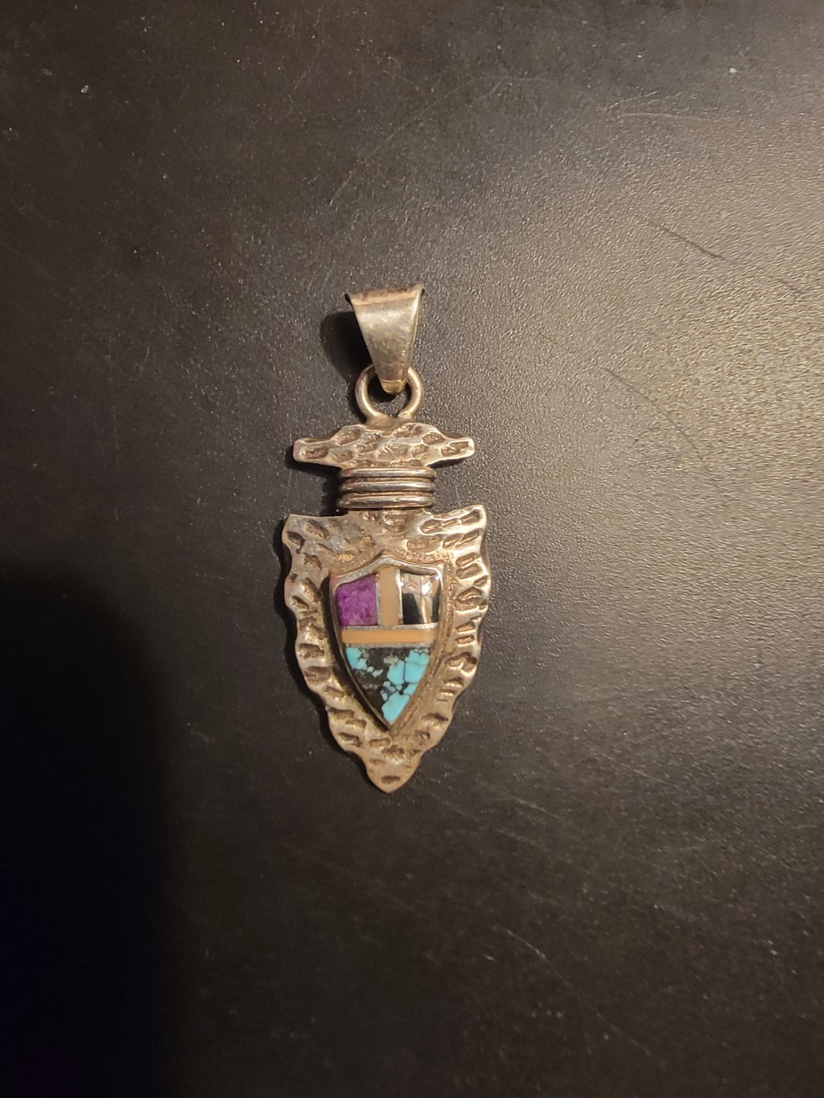 Sterling Silver arrowhead pendant features a detailed shield design