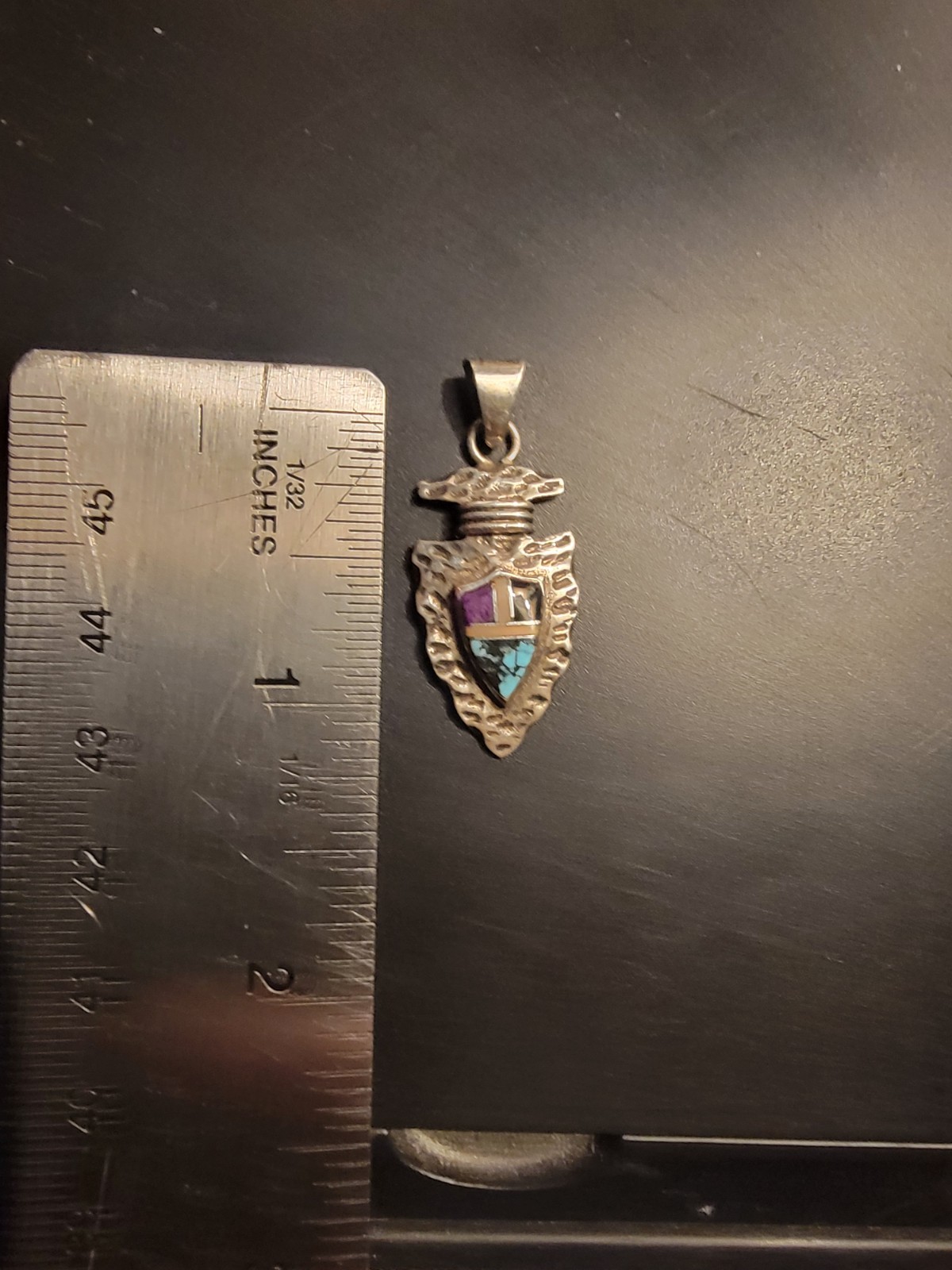 Sterling Silver arrowhead pendant features a detailed shield design