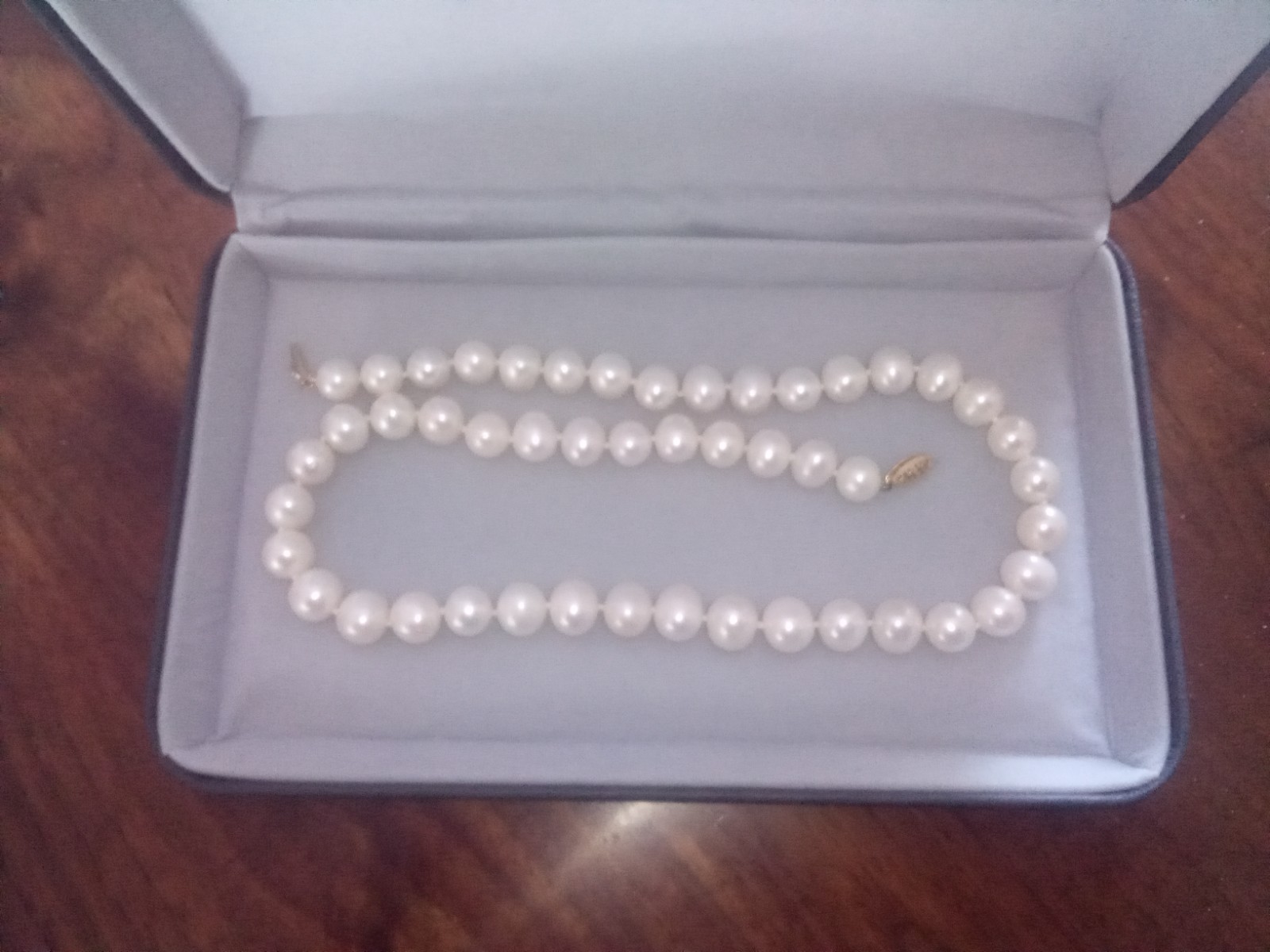 Cultured pearl necklace 18″ long with original box.