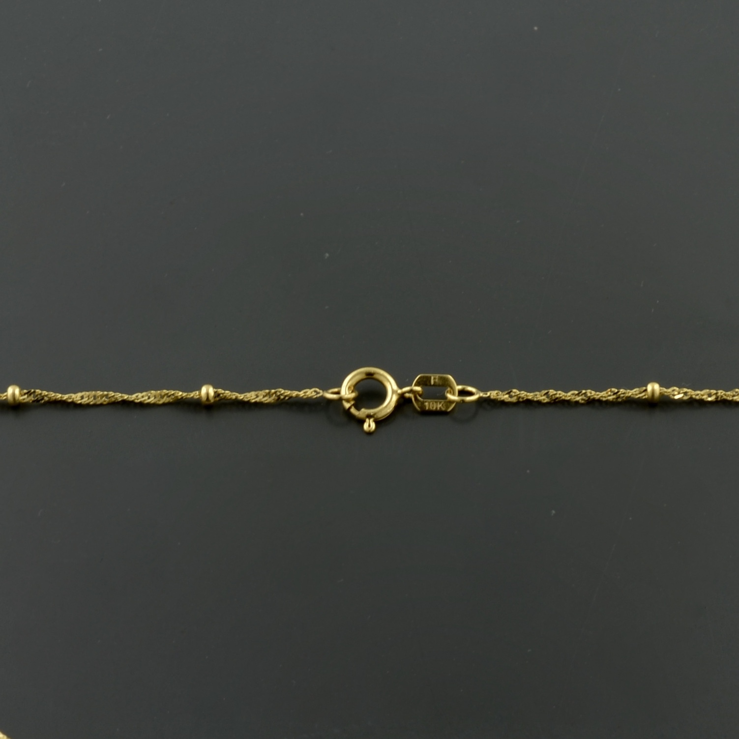 10K YELLOW GOLD 1.0MM SINGAPORE SATURN CHAIN W/1.9MM BEAD STATIONS