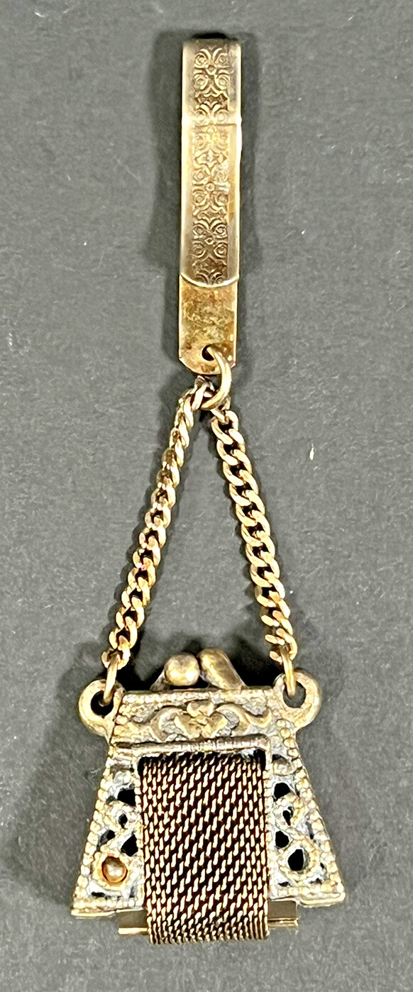 Gold tone opening vintage purse with convenient clip.