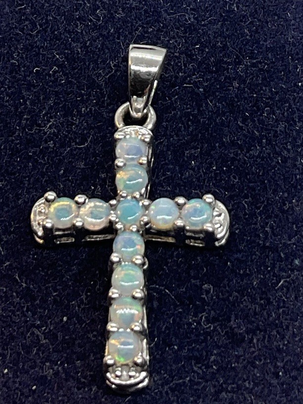 a sterling silver cross pendant With Prong Set Opals. In Excellent Condition.