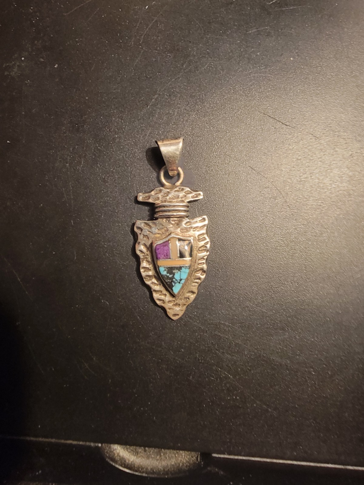 Sterling Silver arrowhead pendant features a detailed shield design