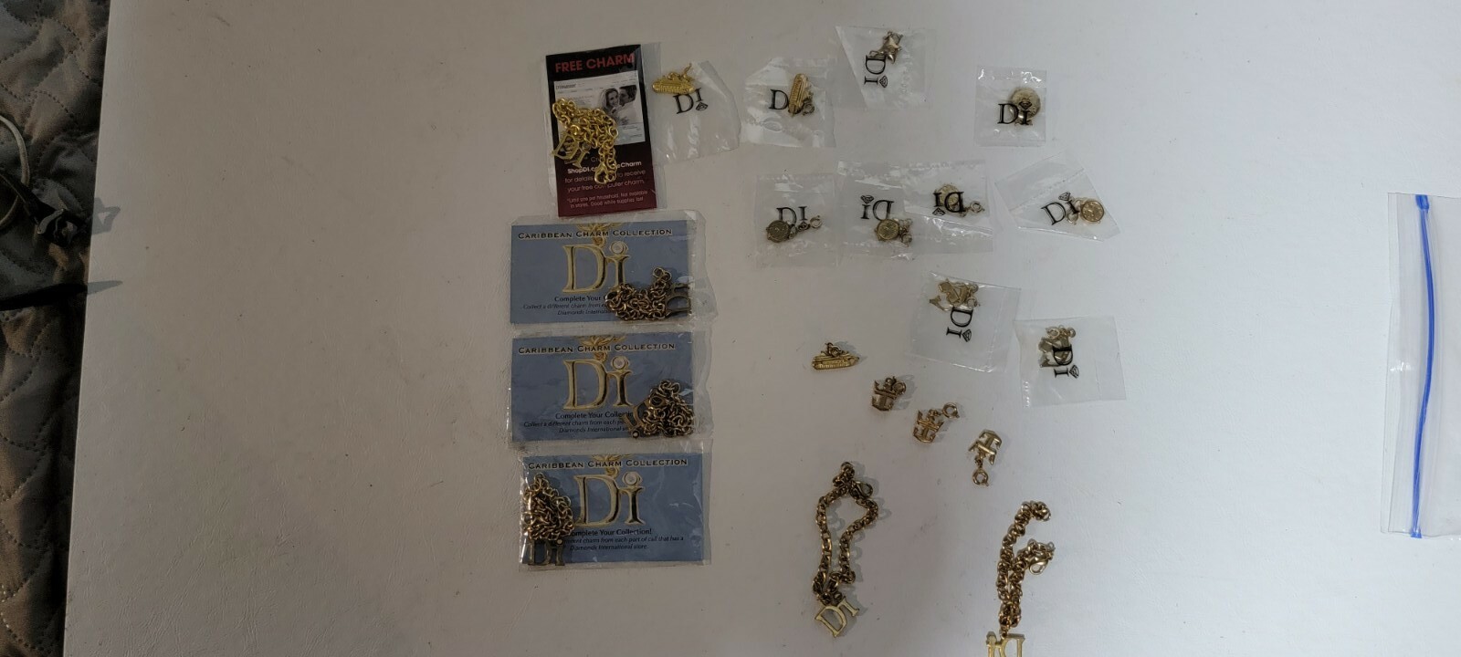 Lot of Gold Tone Di Diamond International Charm Bracelets and charms (G10)