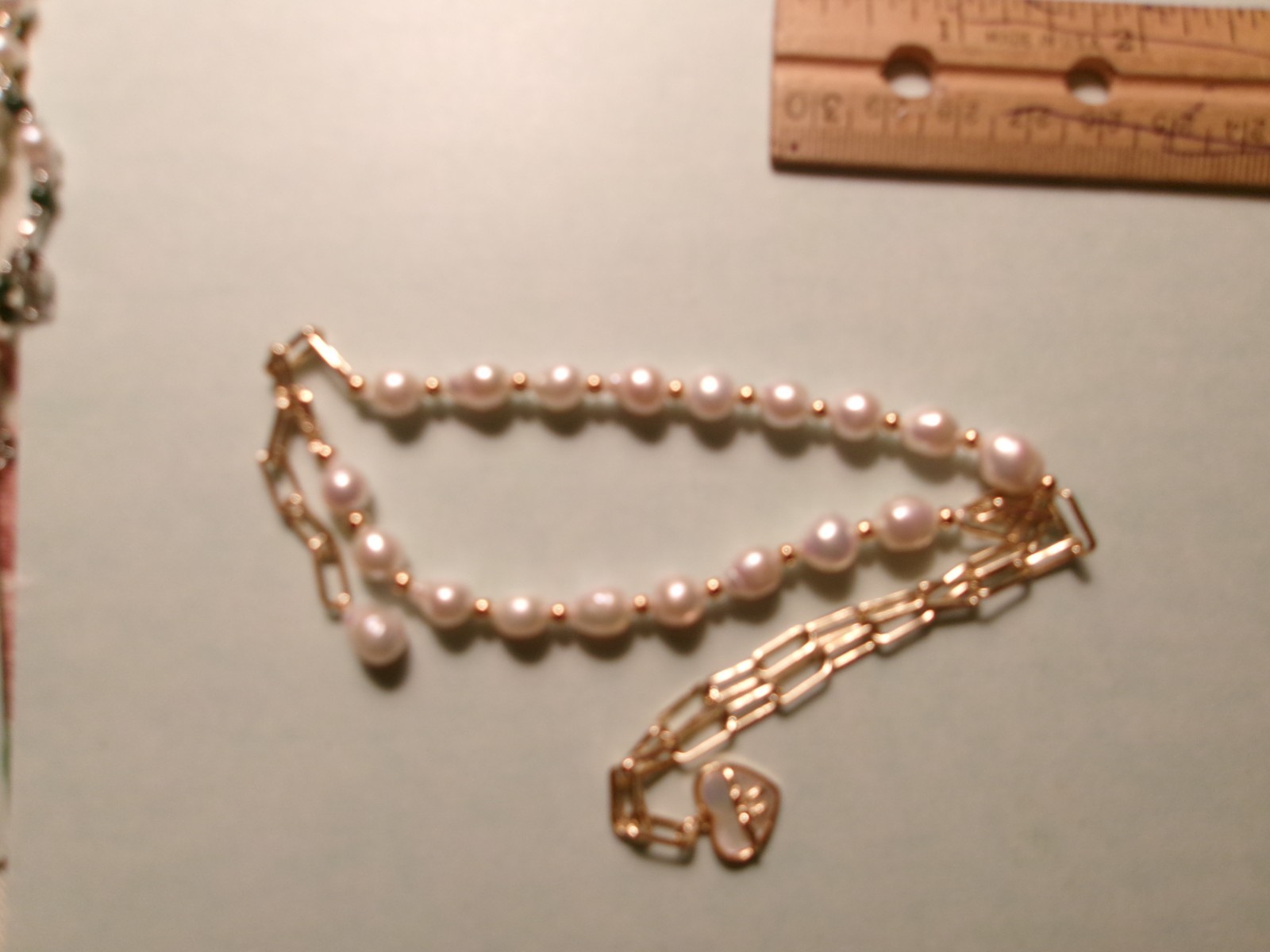 PEARL NICE SIZE REAL PEARLS…THE HEART HAS LIKE A WHITE SHELL INSIDE IT