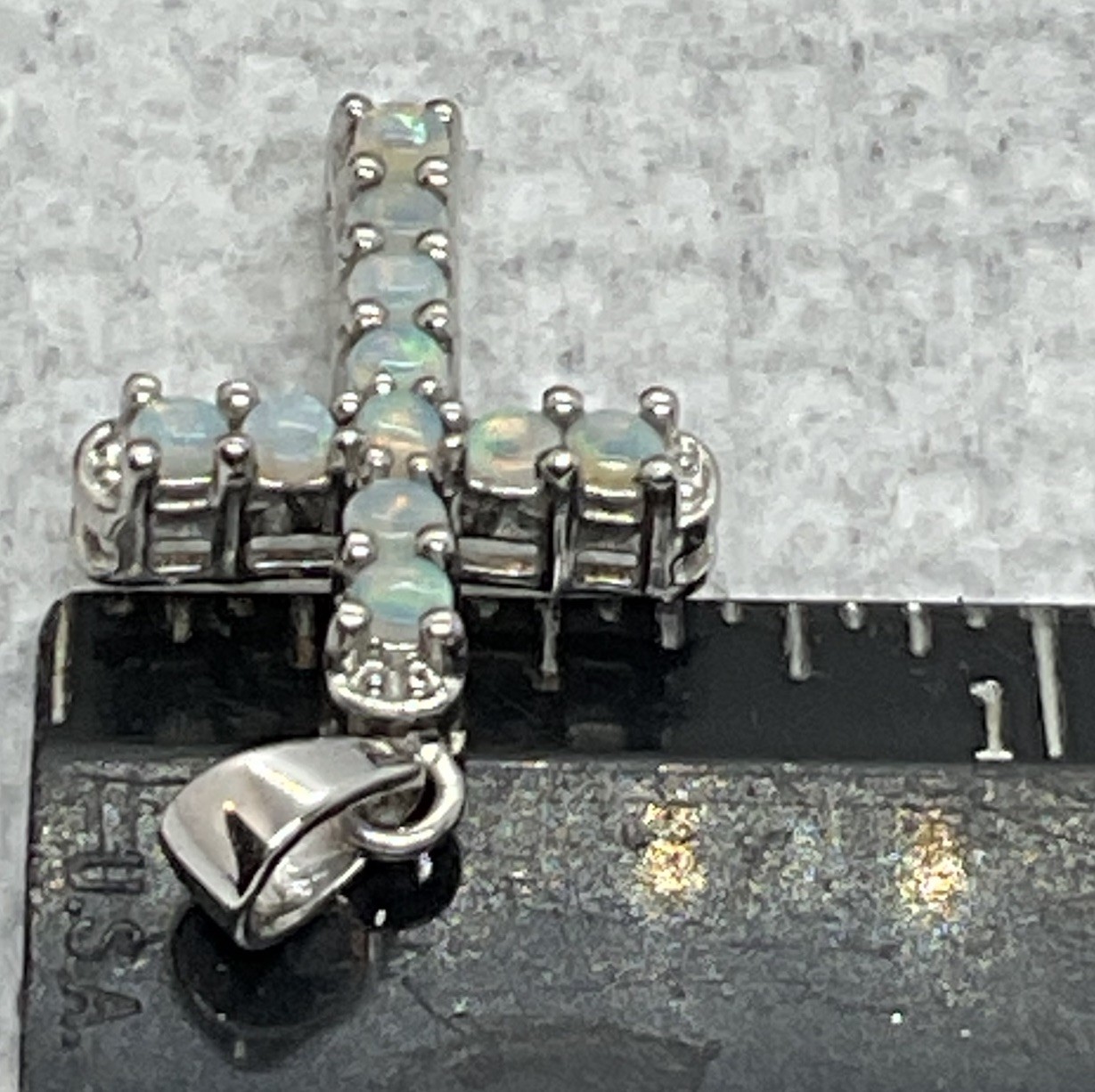 a sterling silver cross pendant With Prong Set Opals. In Excellent Condition.