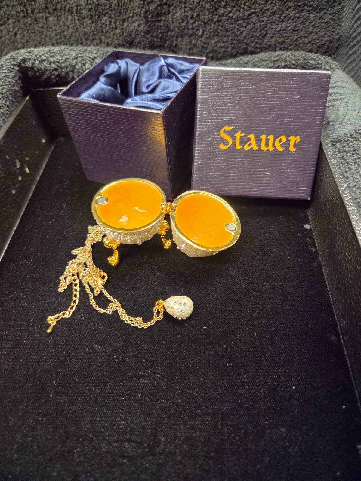 Stauer Egg Silver with Gold Gems in silk lines box with matching egg pendent