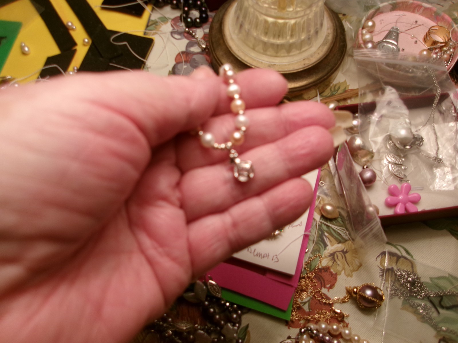 PEARL BRACELET HAS A GLASS DIAMOND IN A CAGE