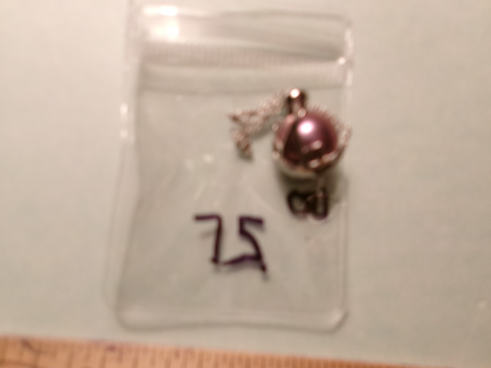 PEARL IN CAGE ABOUT 12.50 TO 13MM BETWEEN.COLOR FABULOUS I PAID 75.00 FOR THE P