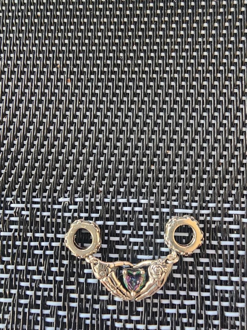 silver lucky charm with heart shaped mystic topaz stamped 925